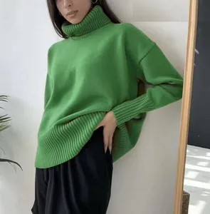 Macro detail view of a soft grass-green turtleneck knitted sweater worn by a model