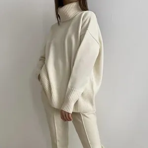 Close-up of cream-white high neck knit sweater showing soft texture and oversized fit