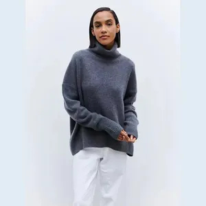 Detail shot of a soft dark grey turtleneck sweater with a cozy oversized fit.