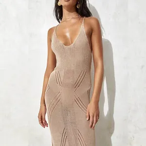 Close-up of the detailed texture of a beige knitted crochet beach maxi dress for resort