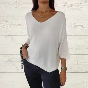 Detail view of a white loose-fit V-neck knit sweater with stylish 3/4 length sleeves