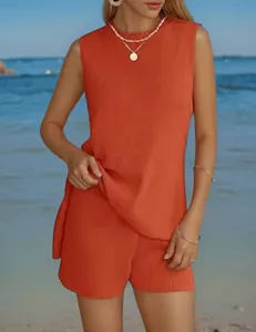 Detail showing the texture and fit of orange casual sleeveless top and shorts