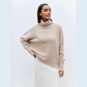 Close-up of women's soft beige high turtleneck knit pullover with ribbed edges