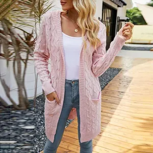 Pink long-sleeved hooded cable knit cardigan worn by a model in an outdoor setting