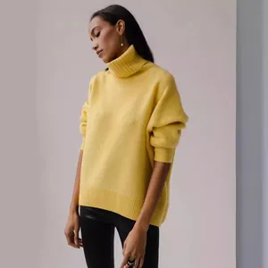 Soft oversized yellow turtleneck knit sweater featuring long sleeves and ribbed trim