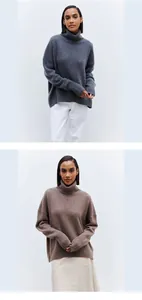Detailed view showing grey and brown oversized turtleneck knitted sweaters in a studio setting