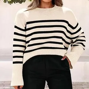 Close-up view of a stylish black and white striped loose-fit knit sweater with wide sleeves.