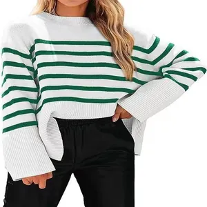 Detail view of white and green striped knitted sweater with loose wide sleeves