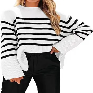 Detailed shot of a black and white horizontal striped knit sweater with loose sleeves.