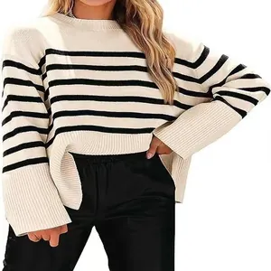 Close-up of cream and black striped knitted sweater with oversized sleeves