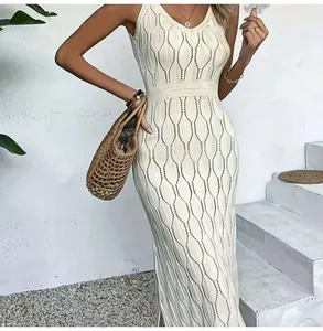 Close-up view of elegant white hollow-out knitted maxi dress for beach resort and vacation