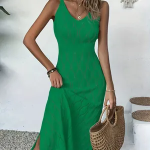 Detailed shot of green sleeveless knitted beach dress with hollow-out pattern for vacation