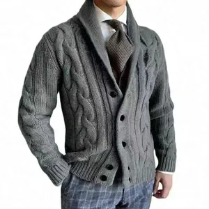 Detailed view of grey cable-knit cardigan featuring a shawl collar and button front style