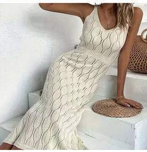 Detail of intricate hollow-out knit pattern on white sleeveless beach midi dress.