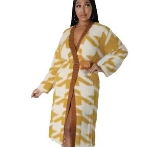Detailed view of yellow and white geometric houndstooth pattern long knit cardigan