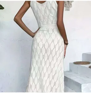 Close-up of the intricate hollow-out leaf knit pattern on white beach maxi dress