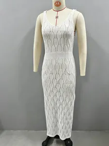 Detail view of a white knitted maxi beach dress featuring a delicate hollow-out leaf pattern