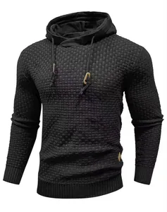 Close-up of men's knitted hooded sweater featuring waffle texture and toggle detail