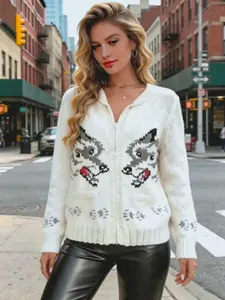 Close-up of white knit cardigan with symmetrical wolf jacquard and front zipper