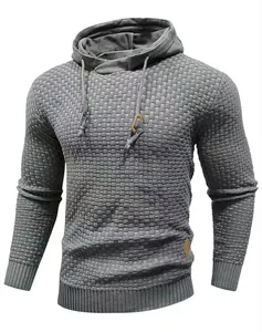 Close-up showing the textured weave and hood detail of the grey men's knit sweater.