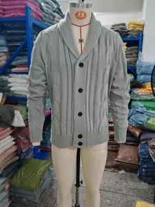 Detail of a men's grey cable knit shawl collar cardigan shown on a clothing mannequin.