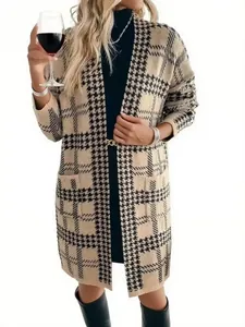 Full length detail of an elegant houndstooth knit cardigan with pockets on model