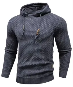 Close-up detail of a men's textured charcoal grey knit hoodie with premium drawstring