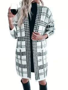 Full-length view of a women's black and white houndstooth knit long cardigan coat