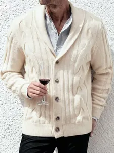 Close-up of men's cream cable-knit shawl collar cardigan with buttons and ribbed cuffs