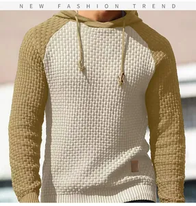 Detalle de sudadera con capucha de punto gofrado bicolor para hombre de corte entallado.