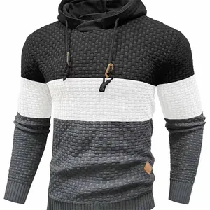 Detailed view of men's color-block hooded sweater with waffle knit texture and drawstrings