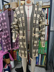 Long houndstooth knit cardigan sweater for women displayed on a studio mannequin