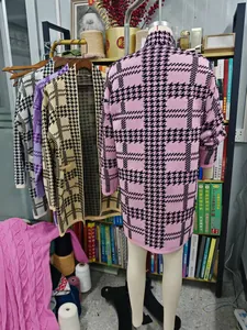 Back view detail of colorful houndstooth long knit cardigans displayed in a studio
