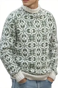 Détail du motif géométrique complexe en jacquard vert et blanc sur le pull en maille