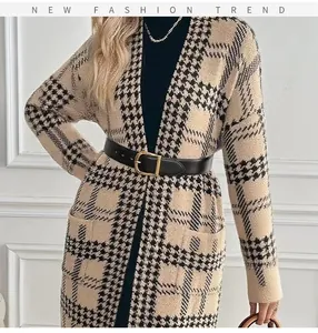 Close-up of stylish houndstooth long knit cardigan featuring a black belt and pockets
