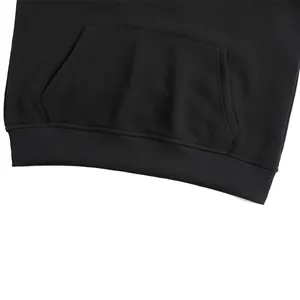 Close-up detail of a black smart heating hoodie with kangaroo pocket and ribbed hem