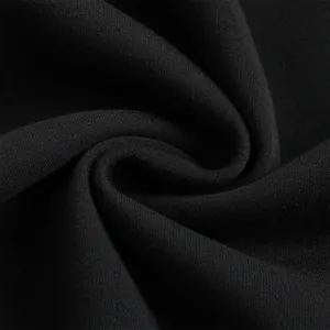 Close-up of black fleece hoodie fabric showing soft knit texture and weave