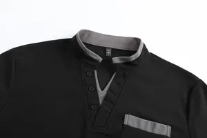 Detail view of men's black polo shirt with grey stand collar and button placket