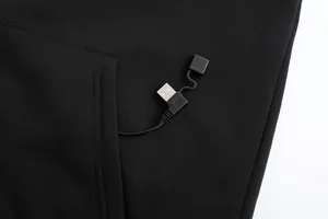 Detailed close-up of the integrated USB charging cable inside a black heated hoodie