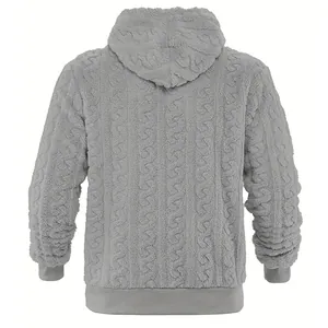 Close-up detail of gray cable-knit fleece hoodie showing thick and warm fuzzy texture.