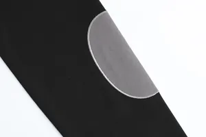Close-up of grey patchwork stitching on a black autumn men's sweatshirt or Polo shirt