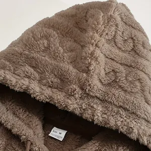 Close-up of brown fleece texture and size tag on men's winter hoodie