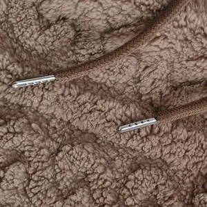 Close-up detail of warm brown sherpa plush fabric and silver metal tip drawstrings for hoodie