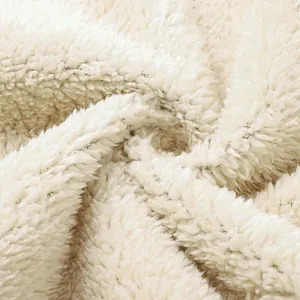 Macro view of soft white Sherpa fleece lining showing thick winter material texture