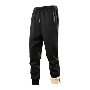Detail of thickened men's winter joggers with warm lamb fleece lining and drawstring waist