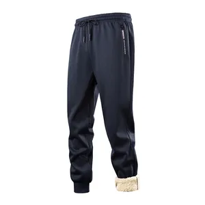 Men's navy blue winter sweatpants featuring thick cream sherpa fleece lining detail at the cuff