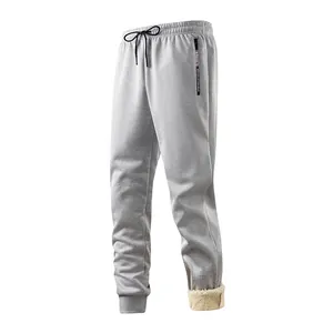 Close-up detail of men's grey winter joggers featuring a warm lamb wool fleece lining