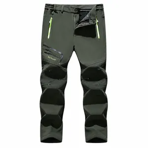 Men's fleece-lined waterproof softshell pants for outdoor hiking and fishing.
