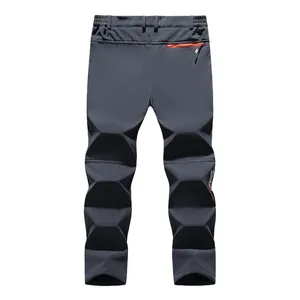 Men's dark grey fleece-lined softshell hiking pants with windproof thermal outdoor design
