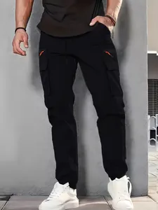 Detailed view of black multi-pocket cargo pants with orange zipper accents